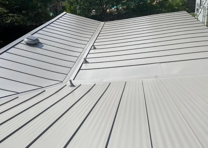 Solar attic fan installed on a metal roof for Roof Ventilation in Cocoa West